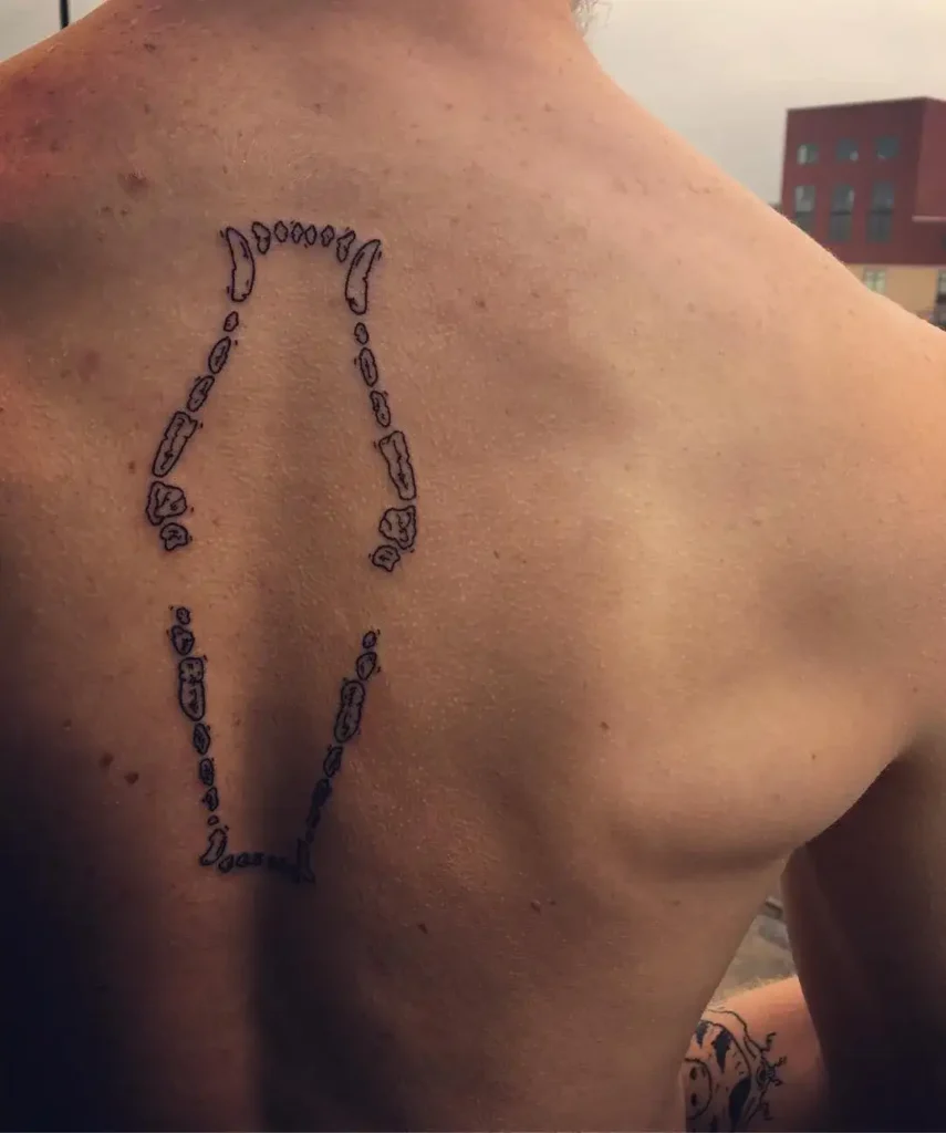 dog teeth tattoo on back 2